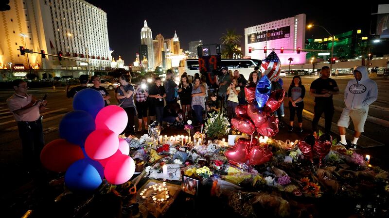 People gather at a makeshift memorial in the middle of Las Vegas Boulevard on Wednesday. Photograph: Chris Wattie/Reuters