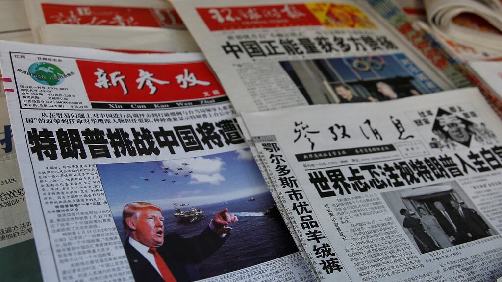 Newspapers in Shanghai on Saturday. The People’s Daily said punitive tariffs and labelling China a “currency manipulator” would lead only to retaliation. Photograph: Reuters