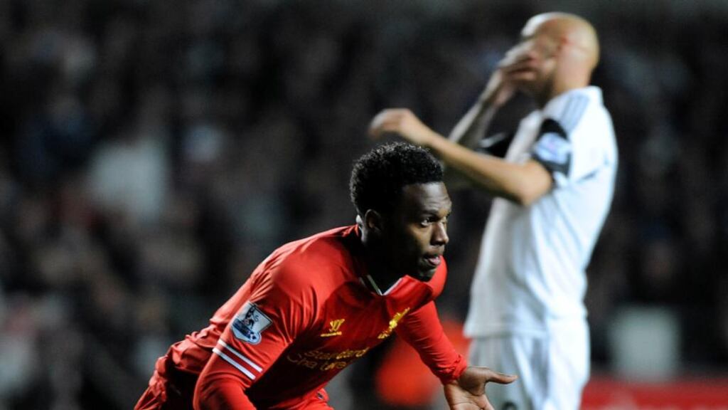Liverpool striker Daniel Sturridge celebrates after scoring as Jonjo Shelvey shows his dejection during last night’s Premier League match at Liberty Stadium, Swansea, Wales. Photograph: Getty Images