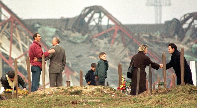Bosnian Muslims greet each other at a cemetery overlooking the Olympic stadium in Sarajevo in 1996. Photograph: Danilo Krstanovic / Reuters