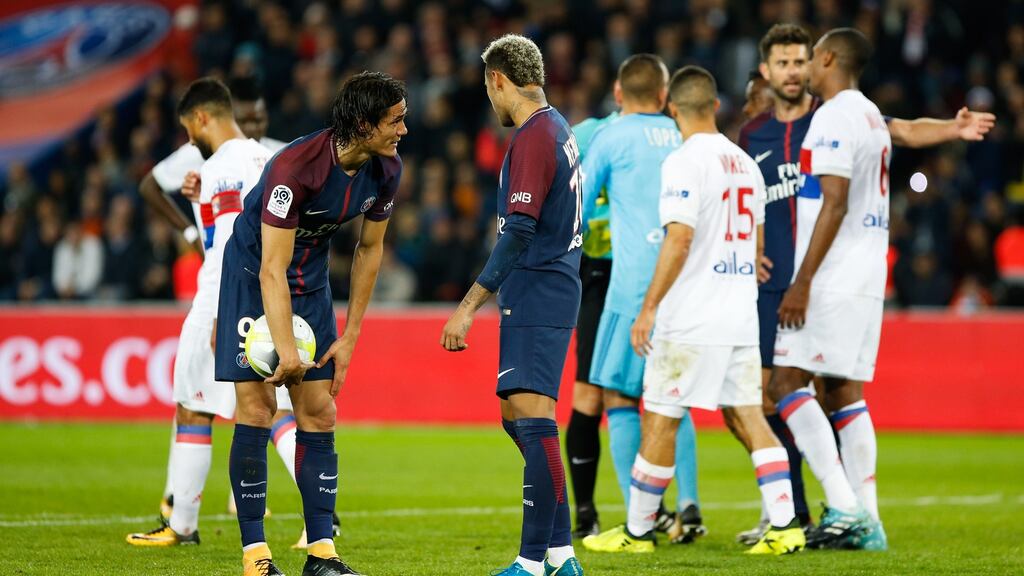 Paris Saint-Germain’s Edison Cavani and Neymar discuss who will take a penalty in their Ligue 1 clash with Lyon. Photo: Johnny Fidelin/Icon Sport/Getty Images