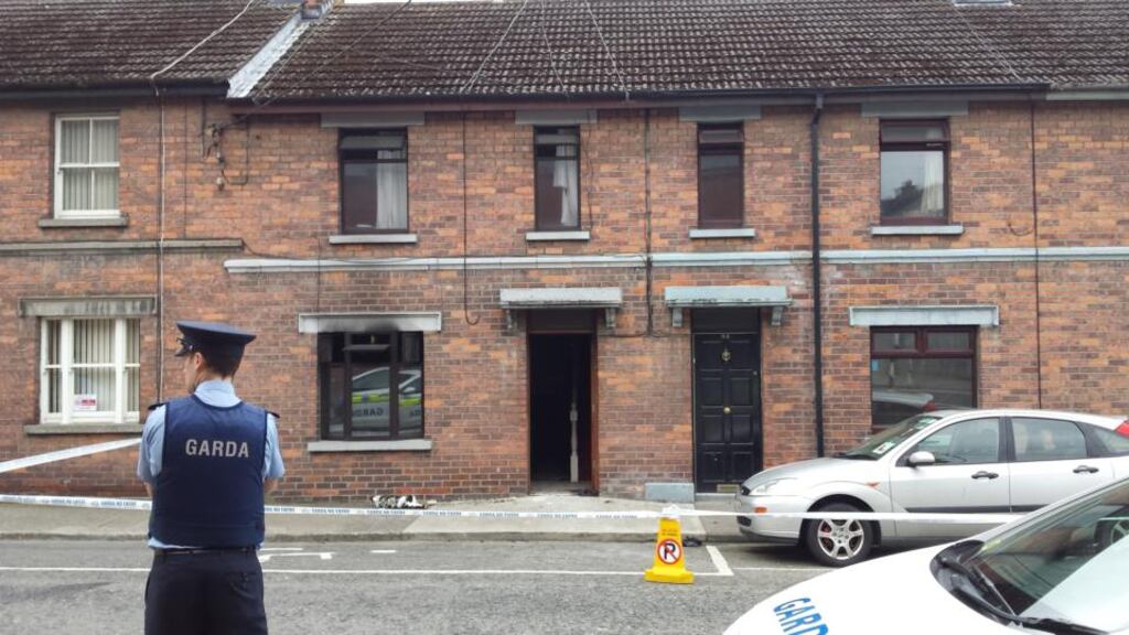 A Garda outside the house on Chord Rd, Drogheda in which an elderly woman was injured in a fire last night. Photograph: Paddy Logue