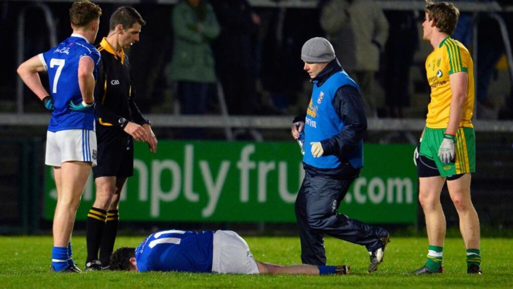 Cavan’s Enda Flanagan lies injured during the game. Photograph: Russell Pritchard/Inpho