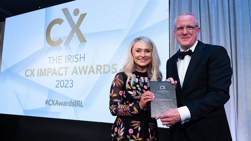 Tim Farmer, awards judge, presents the CX rising star of the year award to April Durnin, AIB.