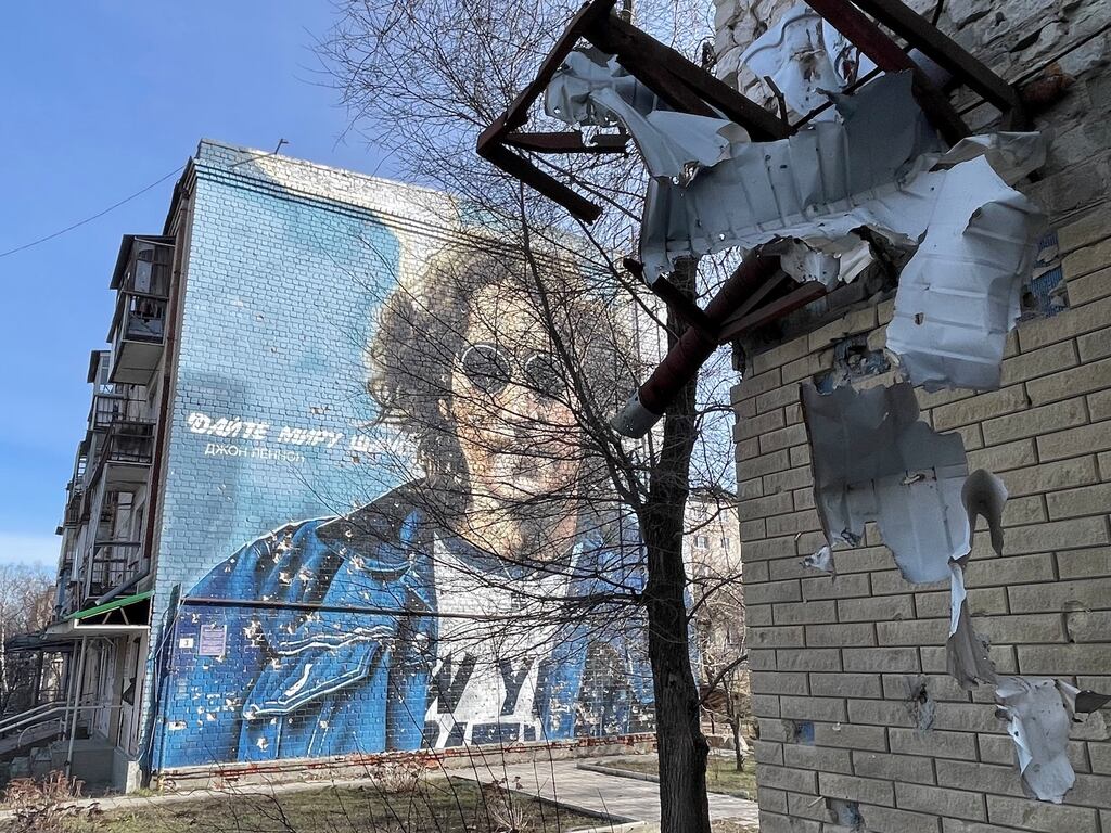 A mural of John Lennon and his lyric 'Give peace a chance' in the Ukrainian town of Izium. The town was severely damaged and many of its people killed during fighting and a five-month occupation by Russian forces in 2022. Photograph: Daniel McLaughlin