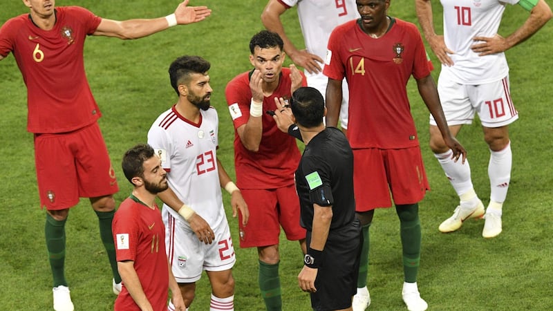 Paraguayan referee Enrique Caceres awards a penalty to Iran at the Mordovia Arena. Photograph: Getty Images