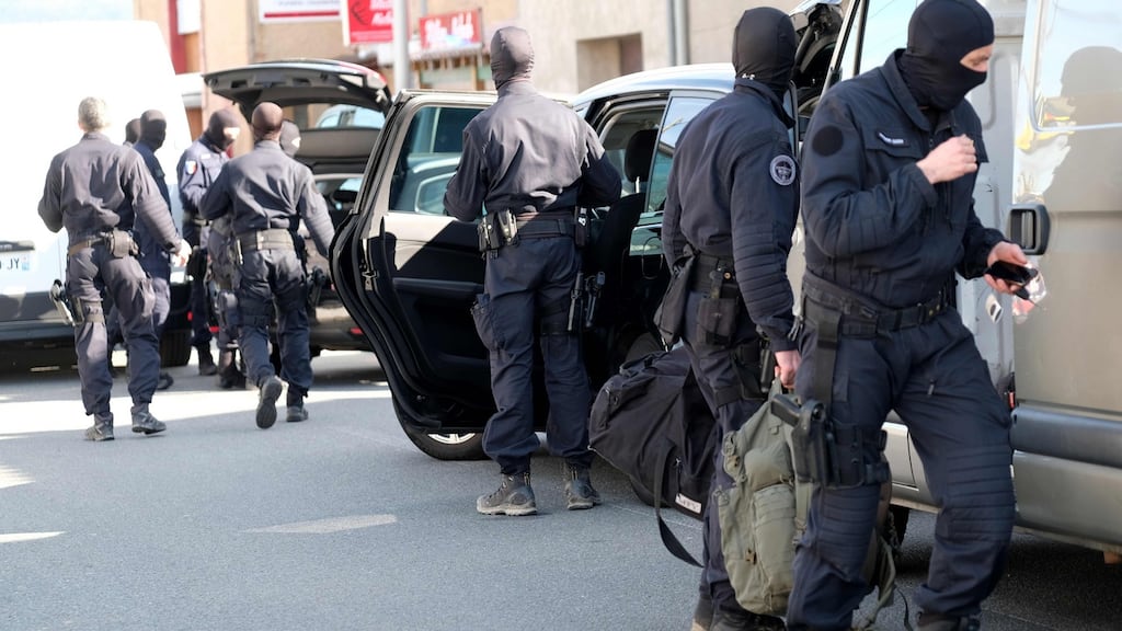 French National Gendarmerie Intervention Group (GIGN) gather outside the Super U supermarket in the town of Trebes, southern France, where a man took hostages on Friday morning. Photograph: Eric Cabanis/AFP/Getty Images