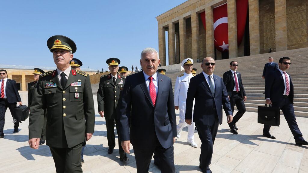 Turkish prime minister Binali Yildirim (C) and chief of staff General Hulusi Akar (L) during a visit to the Mustafa Kemal Ataturk Mausoleum, founder of modern Turkey, before the Turkish Supreme Military Council meeting in Ankara, Turkey, 28th July 2016. Turkish parliament on 21 July formally approved a three-month state of emergency declared by Turkish President Erdogan. Photograph: EPA/STR
