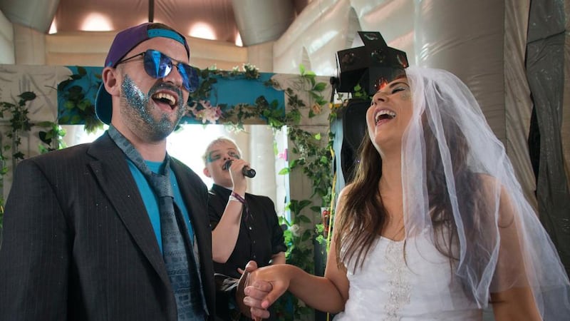 Pop-up wedding: Trevor Luby and Shannon Murphy get “married” by Hannah Maxwell in the inflatable church at Electric Picnic. Photograph: Dave Meehan