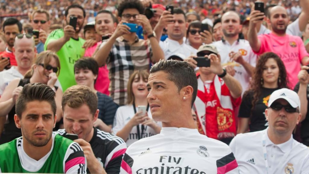 Real Madrid forward Cristiano Ronaldo, front centre, sits with team mates on the bench before the first half of the International Champions Cup match with Manchester United at Michigan Stadium. Photograph: AP