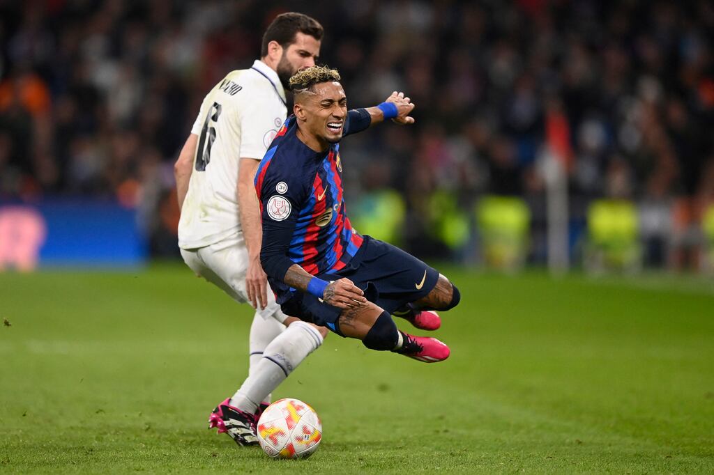 Real Madrid's Nacho Fernandez tackles Barcelona's Raphinha during the Copa del Rey semi-final first-leg match at the Santiago Bernabeu stadium. Photograph: Oscar del Pozo/AFP via Getty Images
