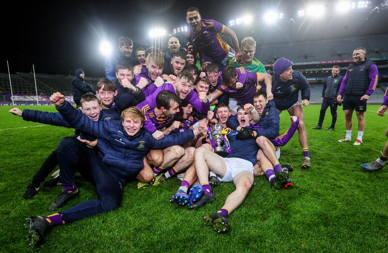 Kilmacud celebrate with the trophy after the win over The Downs. Photograph: Ryan Byrne/Inpho