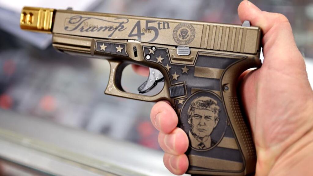 A worker shows off a Glock 19 Donald Trump commemorative 9mm pistol being offered for sale at Freddie Bear Sports in Tinley Park, Illinois. The White House is preparing gun control measures including stricter controls on the purchase of homemade firearms, commonly referred to as ‘ghost guns’. Photograph: Scott Olson/Getty Images