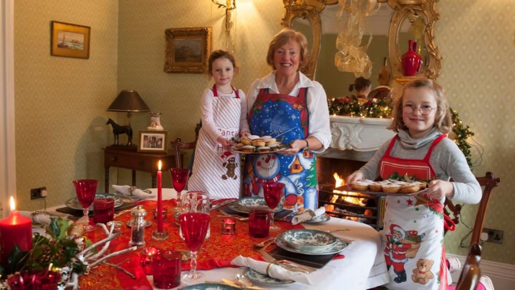 Joan Sheehan photographed in her house in Dungarvan getting ready for christmas with the help of her grandchildren Elizabeth Gill and Emily Gill. Phototgraph: Mary Browne