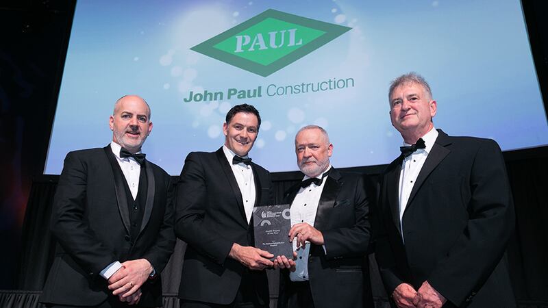 Andrew Howley, Awards Judge, presents the Health Project of the Year award to John Paul Construction team.