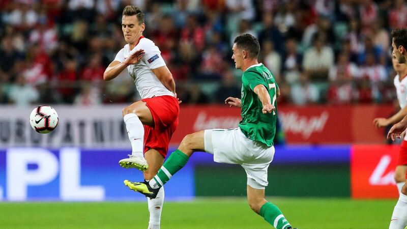 Republic of Ireland midfielder Shaun Williams challenges Arkadiusz Milik of Poland during the friendly international in Wroclaw. Photograph: Ryan Byrne/Inpho