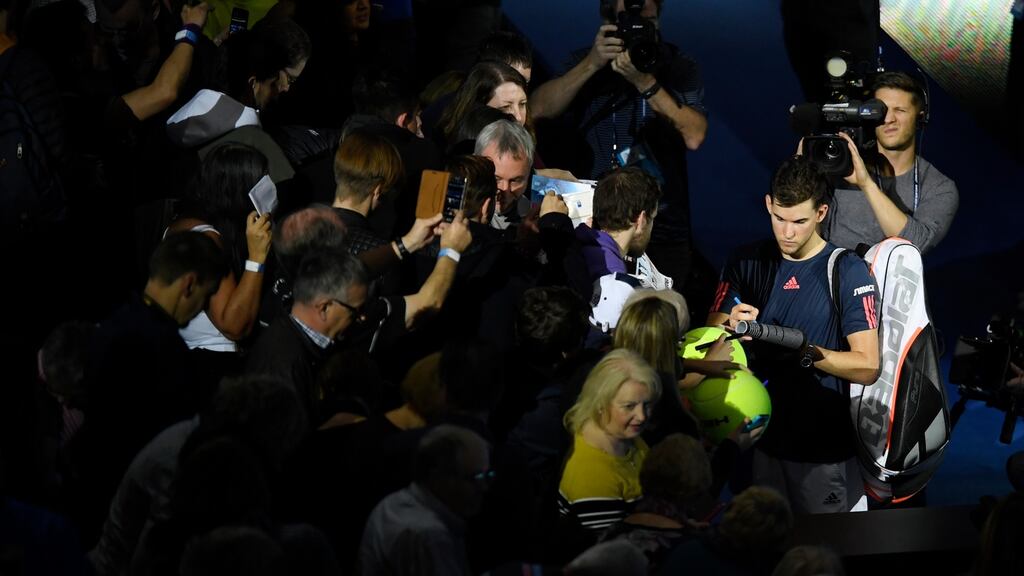 Austria’s Dominic Thiem signs autographs after winning his match with France’s Gaël Monfils. Photograph: Tony O’Brien/Reuters