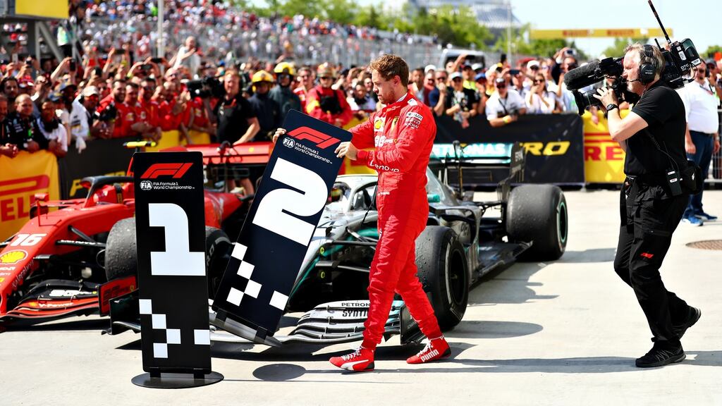 Second-placed Sebastian Vettel of  Ferrari swaps the number boards at parc ferme during the F1 Grand Prix of Canada at Circuit Gilles Villeneuve  in Montreal, Canada. Photograph:  Dan Istitene/Getty Images