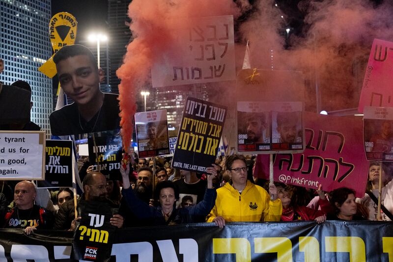 Protesters in Tel Aviv, Israel, hold flares and posters of hostages held in the Gaza Strip during a rally against the Israeli government and demanding the release of all hostages held in the Gaza Strip. Photograph: Amir Levy/Getty Images