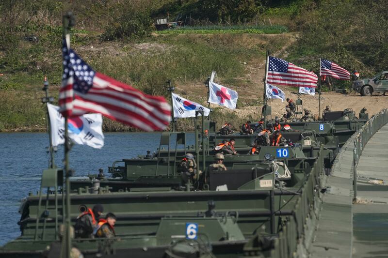 Flags of South Korea and the United States fly before a joint river-crossing drill. Photograph: Lee Jin-man/AP
