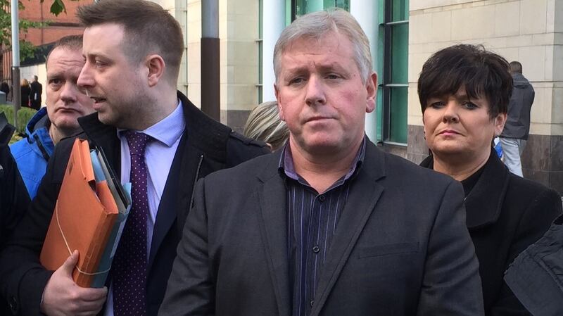 Michael Monaghan (centre), son-in-law of loyalist murder victim Sean McParland, outside Belfast Magistrates’ Court where so-called loyalist supergrass Gary Haggarty has appeared in court for first time in 10 years charged with more than 200 terror offences, including five counts of murder. Photograph: Lesley-Anne McKeown/PA Wire