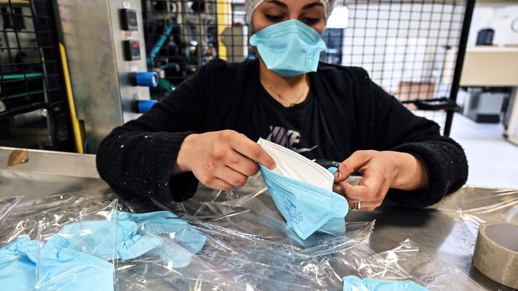 Protective face masks are packed on an assembly line at the Valmy  plant in Mably, central France, amid the spread of Covid-19, the novel coronavirus, to Europe. Photograph: Philippe Desmazes/AFP via Getty
