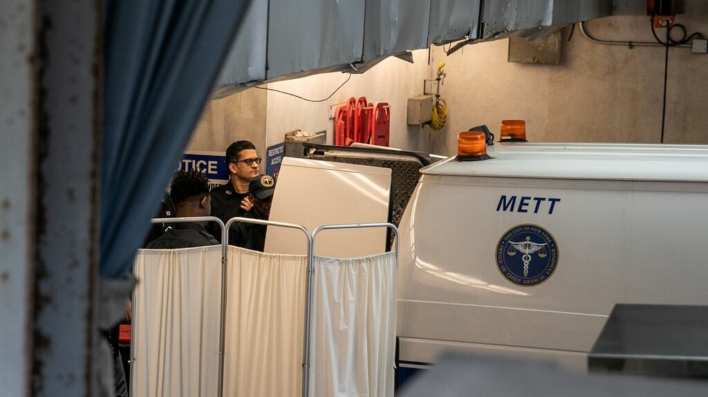 Police officers cover a medical examiner car outside New York Presbyterian-Lower Manhattan Hospital, where Jeffrey Epstein’s body was transported on Saturday. Photograph: Jeenah Moon/Reuters