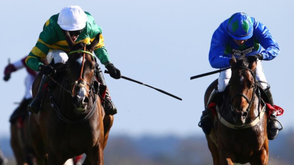 Jockey Mark Walsh onboard Jezki battles it out with Ruby Walsh and Hurricane Fly in the The Ladbrokes World Series Hurdle at Punchestown. Photo: Cathal Noonan/Inpho