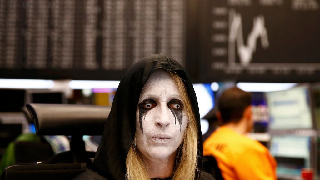 Share traders dressed in carnival costumes work a their desks in front of the DAX index at the stock exchange on Shrove Tuesday in Frankfurt, Germany February 9, 2016. Frankfurt’s bourse traders follow a long tradition by wearing carnival costumes on Shrove Tuesday. (Photograph: Kai Pfaffenbach/Reuters)