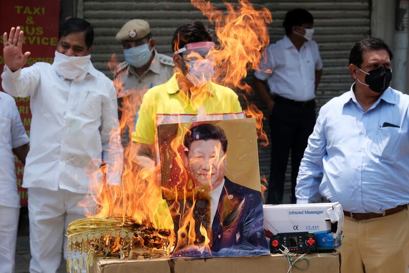 Protesters burn an image of Chinese president Xi Jinping at a demonstration requesting consumers to boycott Chinese goods organised by the Confederation of All India Traders (CAIT) in June 2020. Photograph: T Narayan/Bloomberg via Getty Images