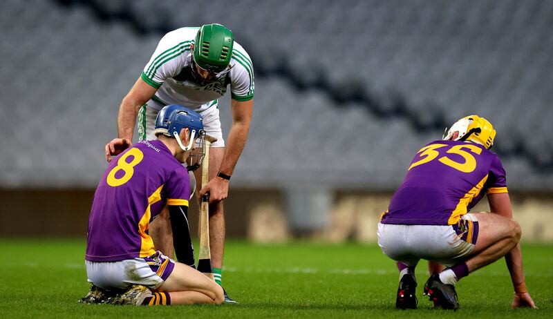 Kilmacud Crokes’ Brian Sheehy and Mark Grogan are consoled by Eoin Cody of Ballyhale Shamrocks at the final whistle. Photograph: Ryan Byrne/Inpho