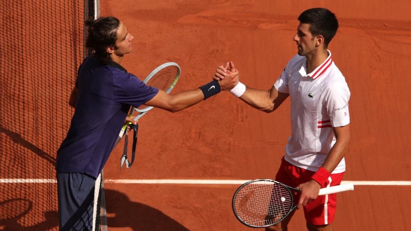 Lorenzo Musetti shakes hands with Novak Djokovic after retiring through injury. Photograph: Adam Pretty/Getty Images