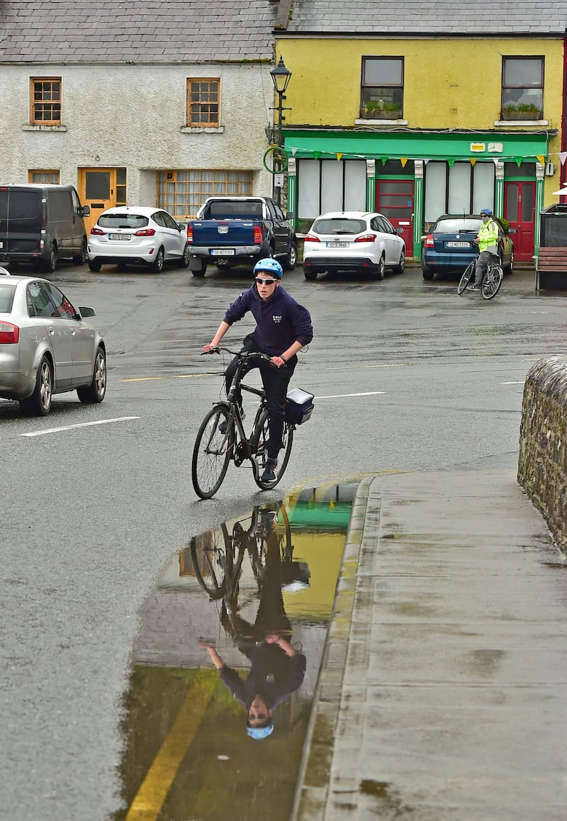 Minding the puddles, a cyclist makes his way around Newport. Photograph: Conor McKeown