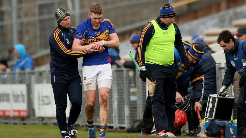 Tipperary’s Denis Maher leaves the field after dislocating his shoulder against Galway at Semple Stadium on Sunday. Photo: James Crombie/Inpho