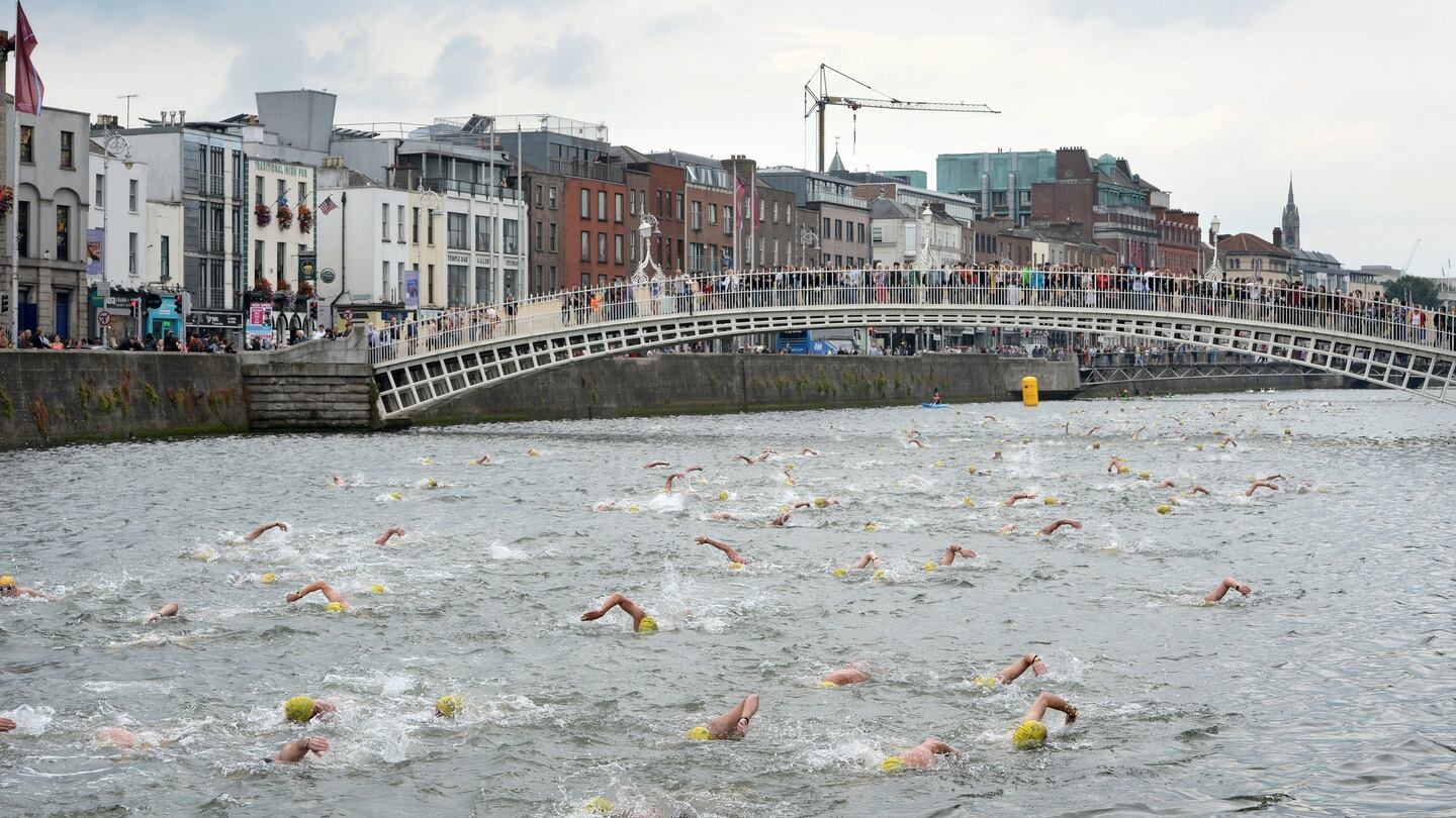 The 100th Liffey Swim, passing the Ha’penny bridge. Photograph: Dara Mac Dónaill/The Irish Times
