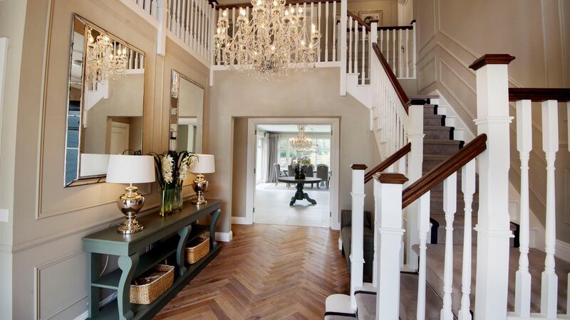 A large 14-arm chandelier fills the void in the 5.4m double-height hall. Interiors were completed by interior designer Arlene McIntyre of Ventura Design