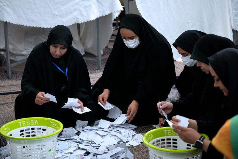 Election officials count ballots for the presidential election at a polling station in Tehran, Iran. Photograph: Vahid Salemi/AP