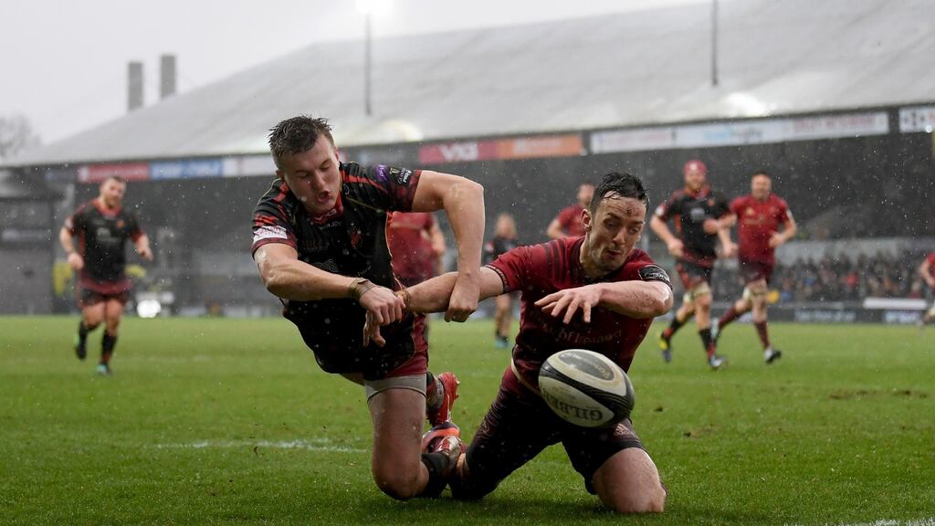Munster’s Darren Sweetnam attempts to beat Will Talbot-Davies of Dragons to the ball during the Guinness Pro 14 at  Rodney Parade. Photograph: Alex Davidson/Inpho