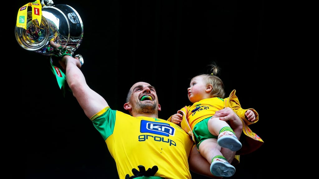 Donegal’s Paddy McGrath lifts the Anglo-Celtic Cup with his daughter Isla Rose after beating Cavan in the Ulster Football Championship final in St Tiernach’s Park, Clones, Co. Monaghan. Photograph: Tommy Dickson/Inpho