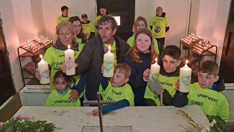 Claire Mould and Charlie Bird with his grandkids after they lit five candles in the church on the summit of Croagh Patrick. Photograph: Conor McKeown