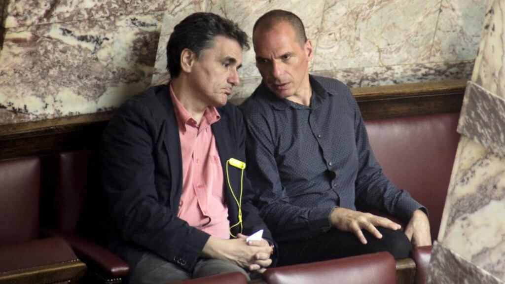 Greek finance minister Euclid Tsakalotos and his predecessor Yanis Varoufakis talk during a parliamentary session in Athens. Photograph: Giorgos Kontarinis/Eurokinissi/Reuters