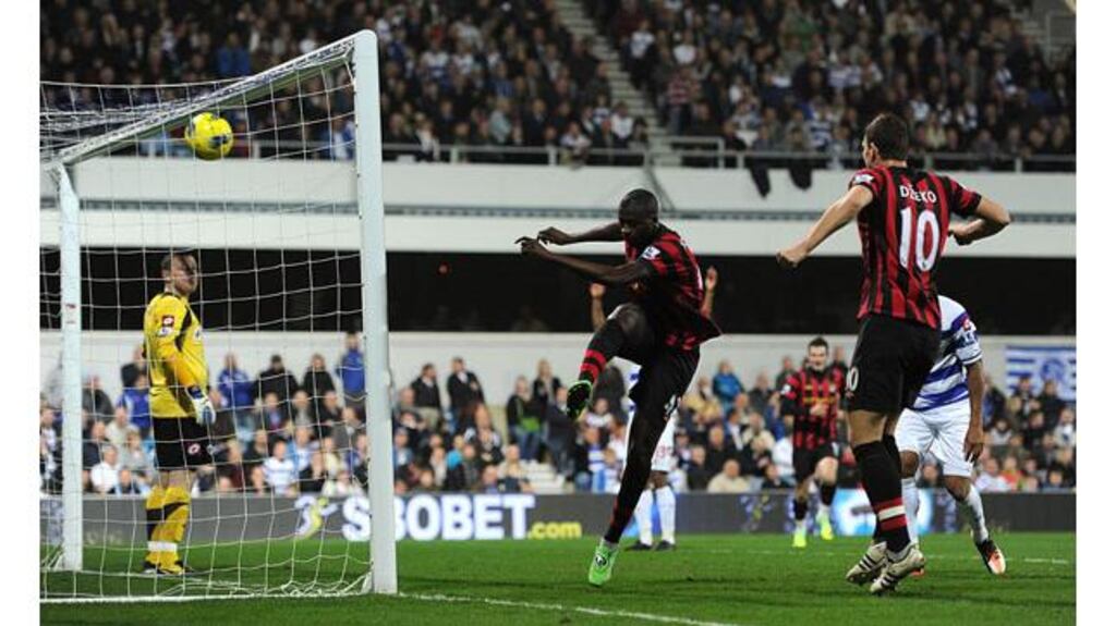 Manchester City's Yaya Toure boots the ball back into the net in celebration after scoring his side's winner at Loftus Road. Photograph: Anthony Devlin/PA Wire.