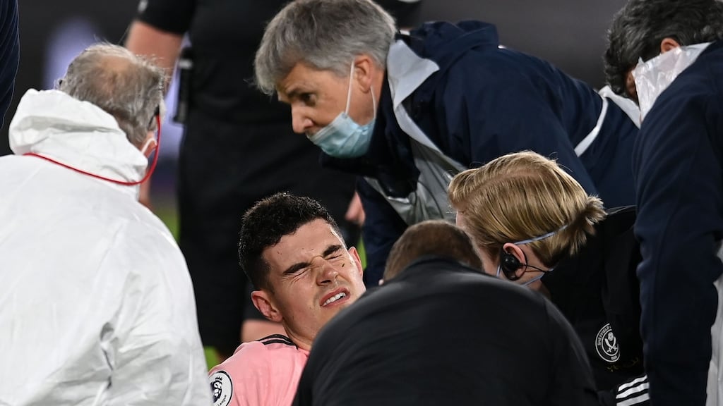 Sheffield United’s John Egan receives medical treatment before leaving the pitch injured during the Premier League clash with West Ham. Photo: Glyn Kirk/Getty Images