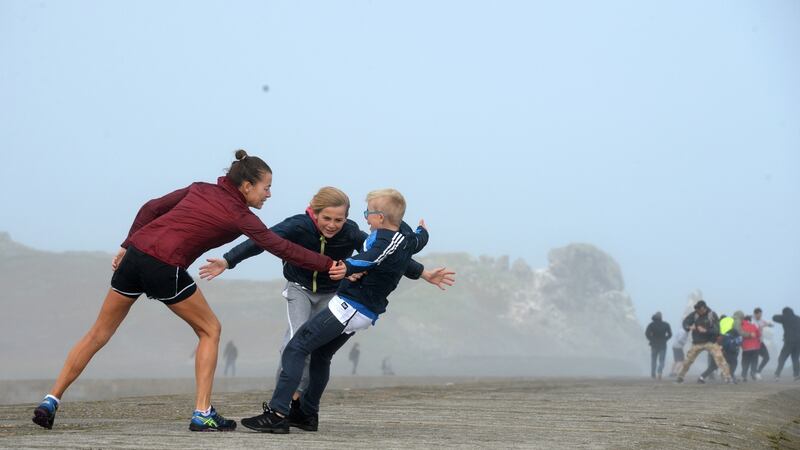 Lying against the wind on the pier at Howth while Hurricane Ophelia hit Dublin. Photograph: Dara Mac Dónaill / The Irish Times