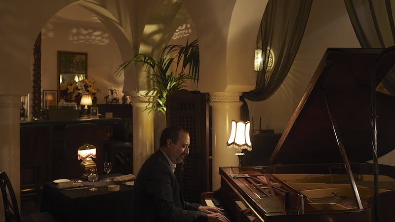 Issam Chabaa, manager of Rick’s Café, plays the piano. Photograph: Ksenia Kuleshova/The New York Times