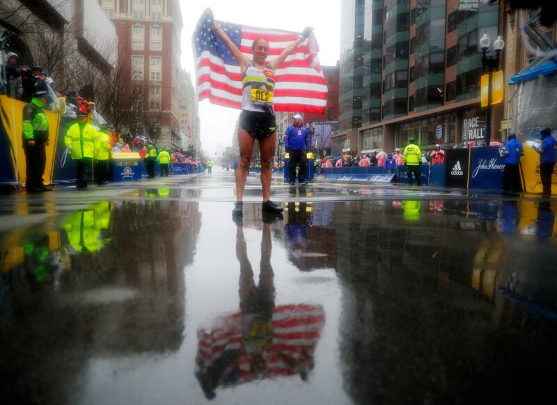 American Desiree Linden celebrates after winning the women's race in the 122nd Boston Marathon.