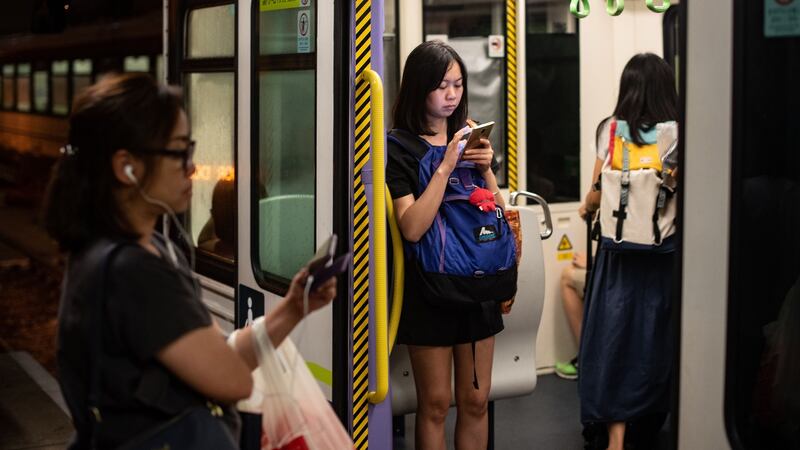 Kan tells a vivid story of ordinary people in contemporary China – from a millennial’s point of view. Above: A train passenger in Tuen Mun district in Hong Kong. Photograph: Philip Fong/AFP/Getty Images)