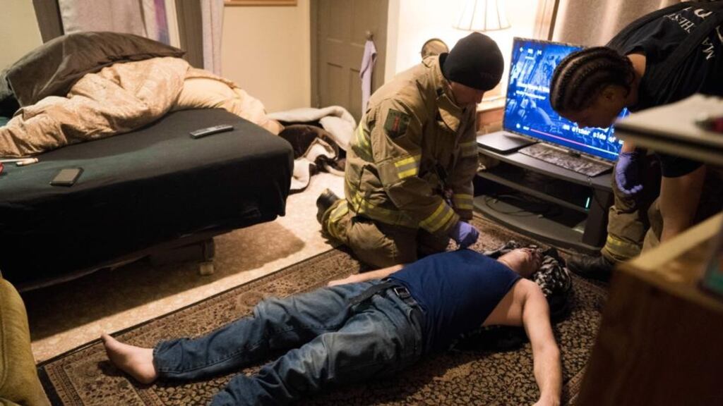 Two members of the Manchester fire department in New Hampshire assess the condition of a man who had overdosed on heroin and who was revived with two doses of Narcan. Photograph: Don Emmert/AFP/Getty Images
