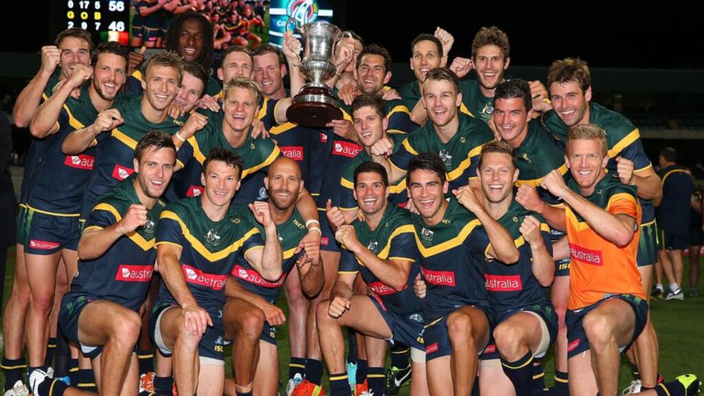 Australian players pose with the Cormac McAnallen Cup after winning the International Rules Test with Ireland at Paterson Stadium in Perth. Photograph: Paul Kane/Getty Images