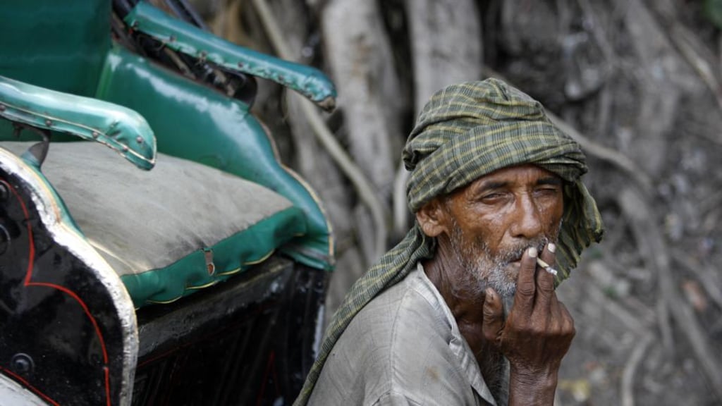 An Indian rickshaw-driver smoking a ‘bidi’ cigarette in Kolkata before India’s ban on smoking in public spaces came into effect, in October2008. Photograph: Deshakalyan Chowdhury/AFP/Getty Images